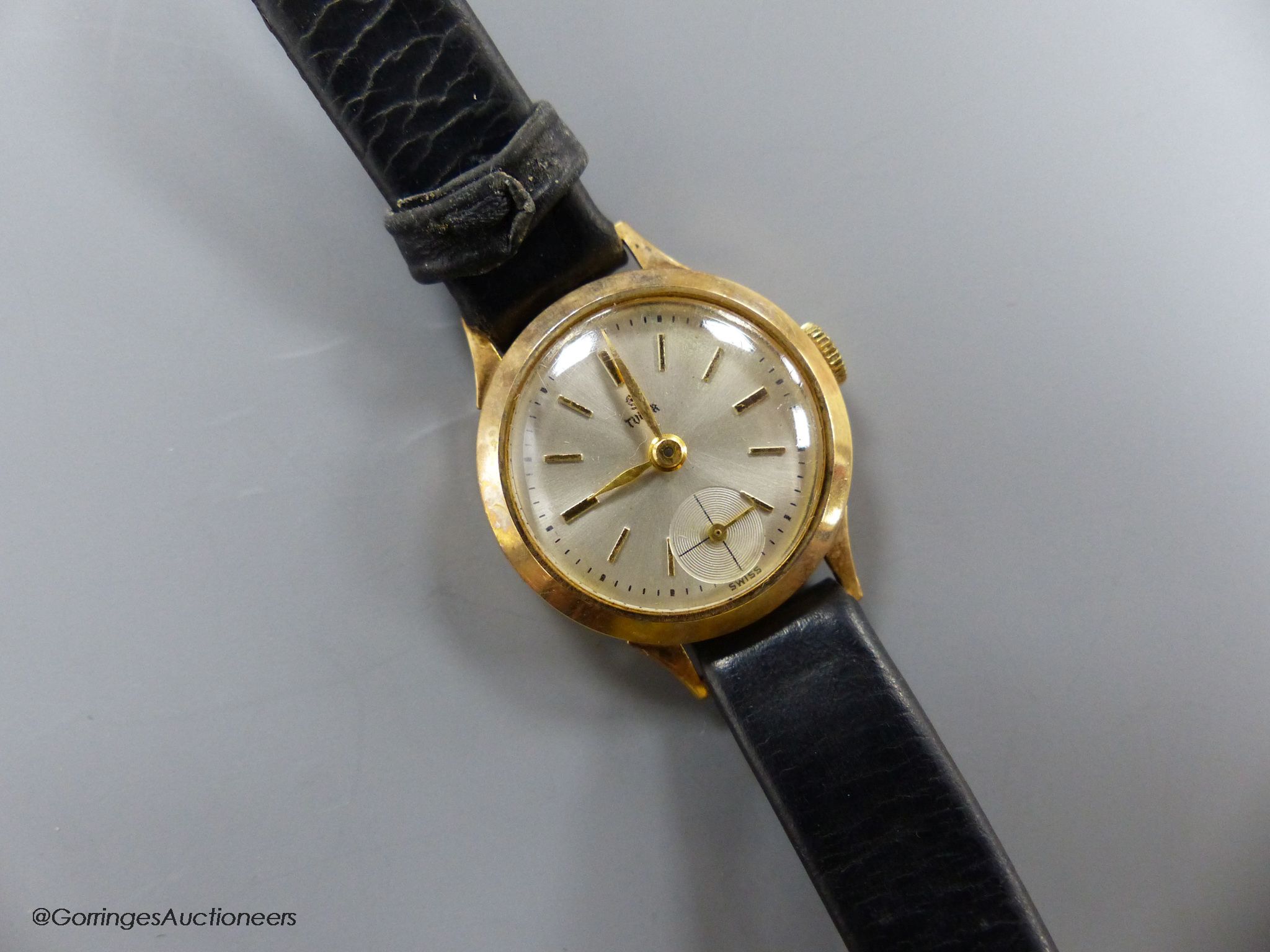A lady's 9ct gold Tudor manual wind wrist watch, with subsidiary seconds, on a leather strap, with gold plated Rolex buckle, with Tudor box.